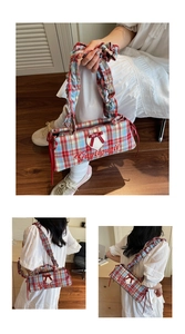 Close-up of red and blue checkered shoulder bag with heart patch and ruffle strap detail