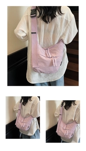 Detail view of lavender crescent bag with adjustable wide strap and knotted zipper puller