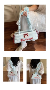 Detail of blue plaid tote bag with red bow, embroidery, and ruffled shoulder strap