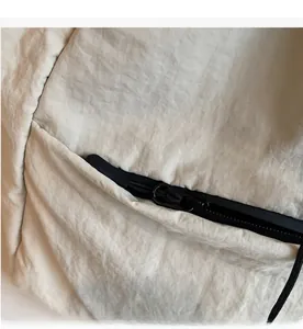 Detail shot of the smooth black waterproof zipper and light textured nylon fabric