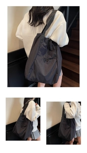 Close-up of black drawstring tote bag showing textured nylon material and large capacity