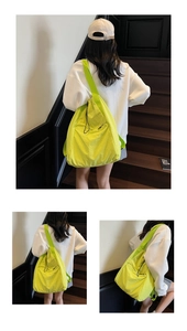Detail of spacious fluorescent green shoulder bag with drawstring and nylon texture