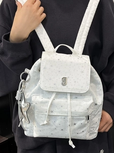 White backpack with silver star prints and metallic g-logo featuring star pendant
