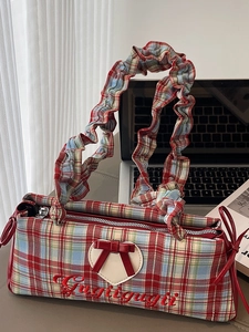 Retro plaid crossbody bag with ruffled straps and heart bow detail on office desk