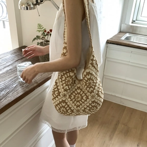 Detail of hand-woven crochet hobo bag showing retro diamond pattern and large capacity