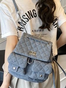 Denim diamond quilted backpack with silver metal chain straps and twist-lock closure