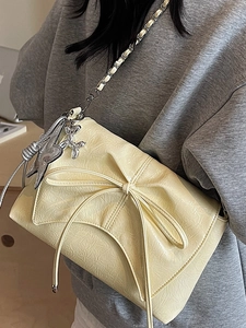 Chic beige pleated underarm bag with bow decoration and stylish chain strap