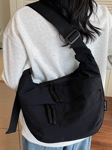 Fashionable black nylon dumpling bag with adjustable wide strap and double zipper closure