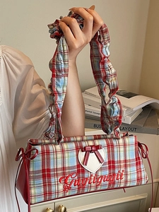 Red and blue checkered handbag with white heart patch and red bow detail