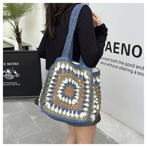 Close-up of bohemian crochet tote bag with colorful mandala pattern in outdoor cafe setting