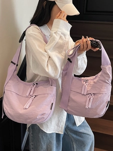 Light purple crescent dumpling bag in wrinkled nylon with adjustable woven strap