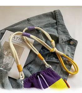 Detailed view of multi-color braided rope strap on a purple and yellow nylon bucket bag