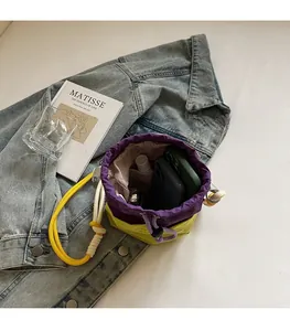 Top view of color-block nylon bucket bag showing spacious interior with drawstring closure