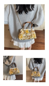 Detail of vintage crossbody bag with bamboo handle, chain strap, and daisy bear prints