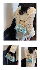 Detailed view of blue floral crossbody bag with bamboo handle and pearl chain strap