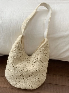 Handmade crochet tote bag with hollow floral pattern in off-white for beach vacations