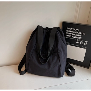 Detail of the high-quality black nylon backpack with a minimalist drawstring closure