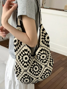 Artistic black and white crochet tote bag with geometric floral patterns for women
