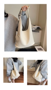 Detailed macro view of off-white lychee texture PU leather tote with a round coin pouch