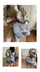 Detail of grey mesh tote bag featuring cartoon dog print and happy quote for daily use
