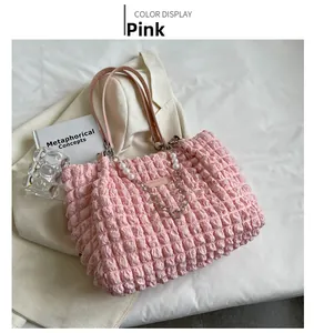 Detailed close-up of pink bubble textured tote bag with elegant pearl and metal chain accent