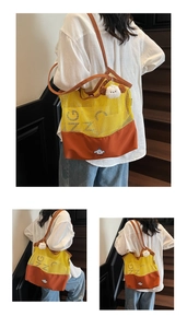 Detail of color-block tote bag featuring mesh fabric and cute cartoon dog illustration
