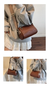 Close-up of brown woven leather bag featuring a patterned ethnic wide shoulder strap