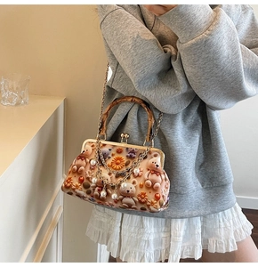 Detail of crossbody bag with bamboo handle, 3D teddy bears, and elegant pearl chain