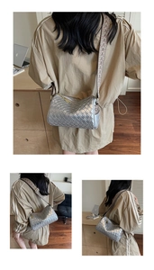 Detailed close-up of metallic silver woven pillow bag with a geometric jacquard strap