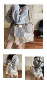 Detail of mesh tote bag showing canvas stitching and plush dog charm accessory