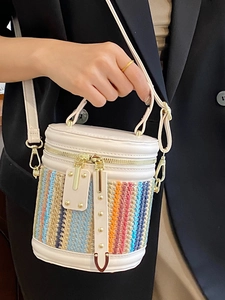 Summer woven bucket bag featuring white leather top and colorful striped straw base design