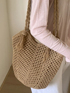 Large capacity woven shoulder tote bag with hollow mesh pattern and long tassels decor