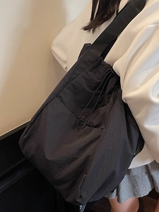 Black large capacity drawstring crossbody backpack with wide strap for casual wear