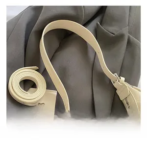 Detailed macro view of the cream crescent bag with textured leather and silver hardware