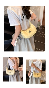 Close-up of a yellow patent leather crescent moon hobo bag with a triangle logo