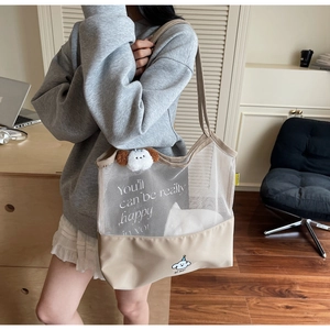 Detail of contrast mesh tote bag featuring a cute cartoon cloud and slogan print