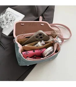 Top view of blue denim crossbody bag interior showing spacious compartments and storage