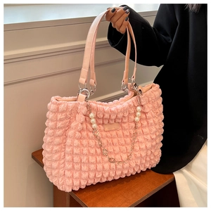 Detailed shot of pink pleated bubble fabric tote bag with pearl and floral chain decoration