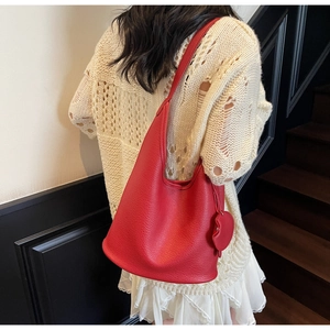 Chic red lychee grain leather hobo bag for women with heart pendant on model