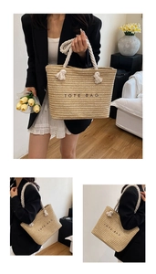 Close-up of woven straw tote bag featuring thick cotton rope handles and black logo text