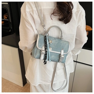 Morandi blue vintage tote bag shown with star charm and long strap on model