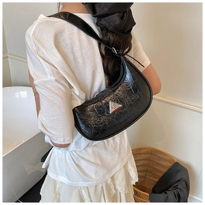 Detailed view of black patent leather crescent hobo bag with vintage crinkle texture