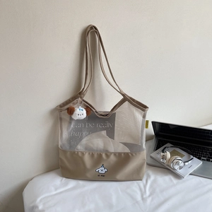 Detail of canvas mesh tote bag featuring a cute puppy illustration and plush keychain