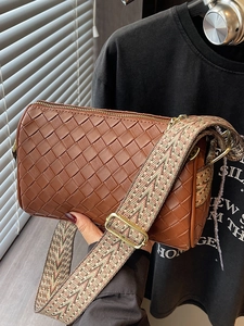 Caramel woven leather pillow bag with geometric jacquard strap and gold zipper details