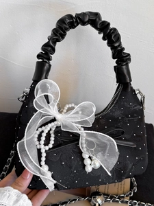 Chic black quilted chain bag with large lace bow and pearl tassels for women