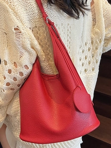Chic red lychee pattern leather bucket bag with shoulder strap and matching tag