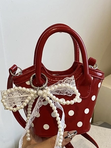 Red polka dot mini handbag with pearl lace bow charm and adjustable shoulder strap