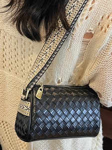Fashionable black woven pillow bag with wide ethnic shoulder strap and gold hardware