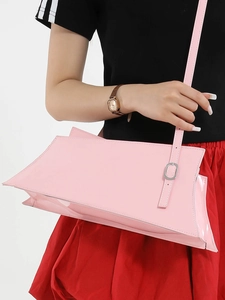 Pink glossy patent leather shoulder bag with adjustable strap and silver metal buckle