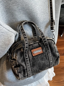 Retro washed denim handbag with leather patch and cross-body strap shown on model